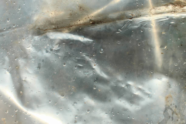 istock Transparent plastic texture with water drops. transparent white plastic background 2184144362