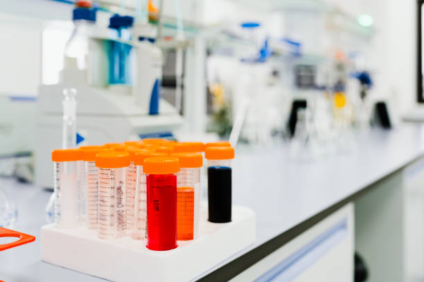 istock Close up of test tubes with different colored liquids on the table. 2184144505