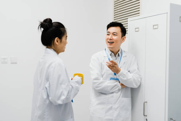 istock Two Asian scientists chatting in the lounge after work. 2184144590