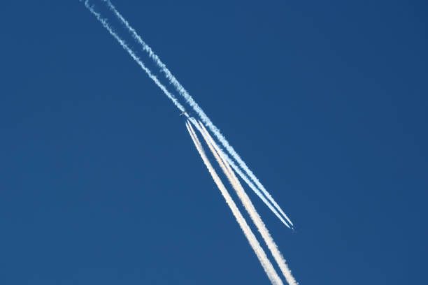 Airplanes in the blue sky with contrails. Shallow depth of field.