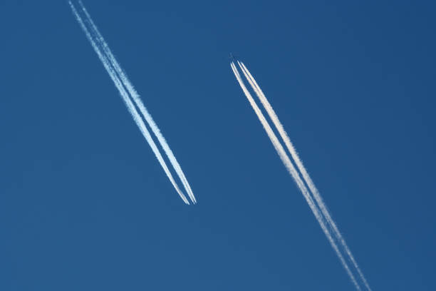 Airplanes in the blue sky with contrails. Shallow depth of field.