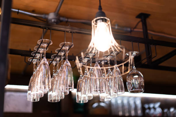 istock Clean, washed and polished glasses hang above bar shelves, blurred background 2184147821