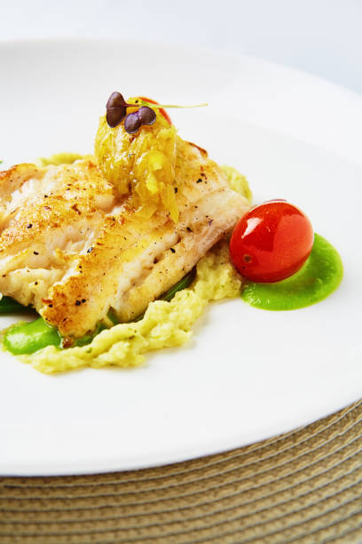 istock Grilled fish served in a fine restaurant with mash, cherry tomatoes and microgreens 2184150258