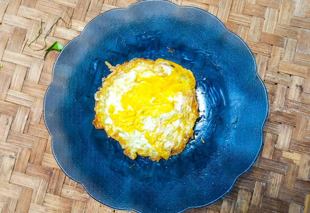 fried egg food in a bamboo waste insulation plate container, taken from the top position