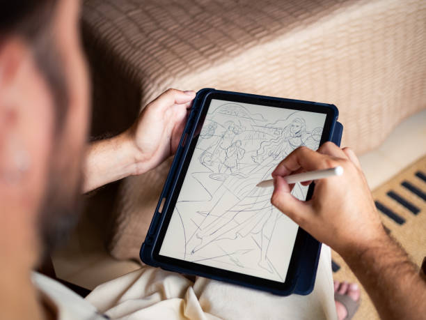 istock Artist sketching a digital drawing on a tablet in a cozy setting 2184150584