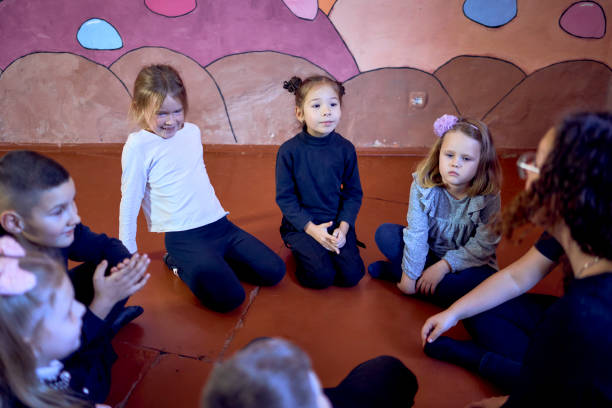 istock 5-7 year old children sit in a circle at an acting class, extracurricular activities 2184151142