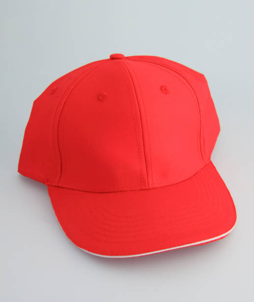 istock Red baseball cap with white brim on gray background 2184153801