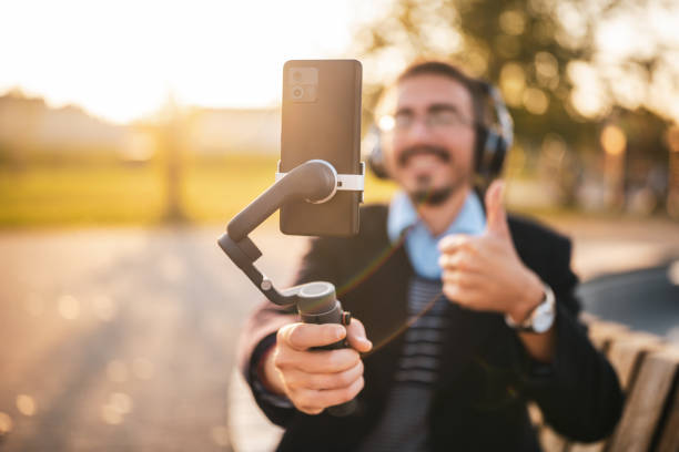 istock Businessman showing thumb up while vlogging outdoor 2184153897
