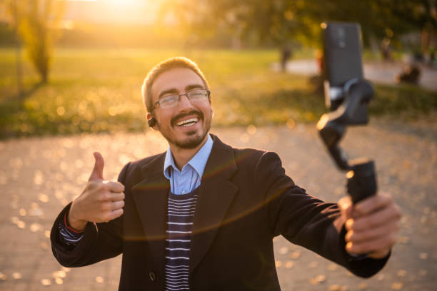 istock Cheerful businessman vlogging outdoor 2184154018