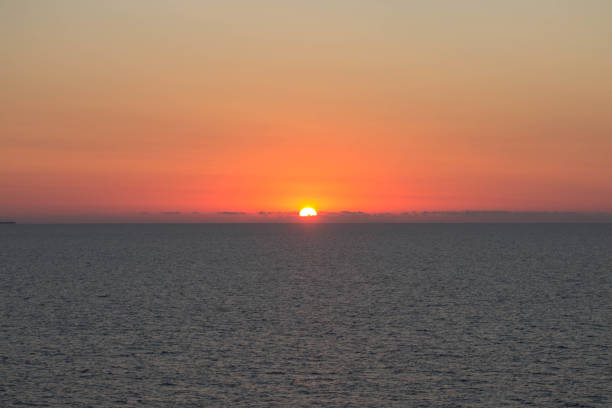 evocative image of sunset over the calm sea on a beautiful day