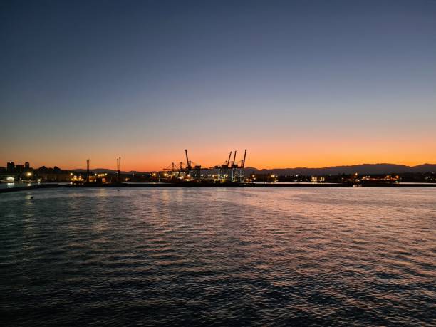 istock the sun setting behind the coast seen from the sea 2184155070
