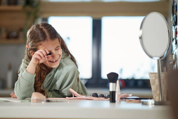 istock Happy girl applying make up 2184155319