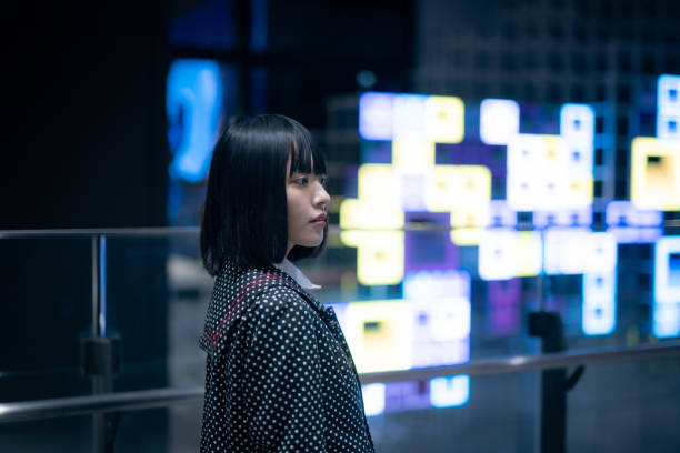 Woman walking in city at night