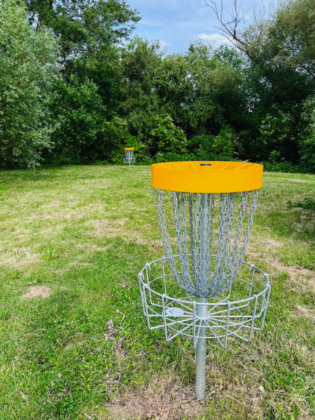 istock Disc golf basket in a scenic park setting with trees and grass 2184156550