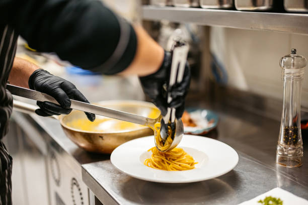 istock Young Chef Making Pasta Carbonara In A Commercial Kitchen 2184156692