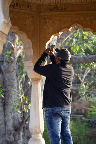istock Man photographing under ornate archway 2184159140