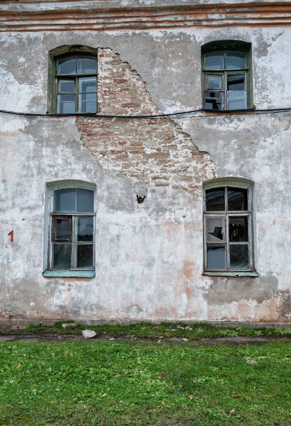 istock Old rustic windows on the ancient abandoned weathered house 2184160099