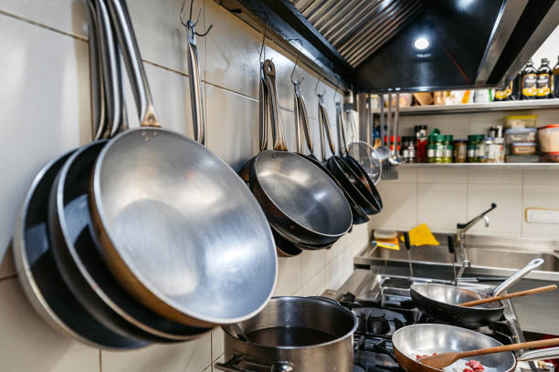 istock Pans Hanging On The Wall In A Commercial Kitchen 2184162953