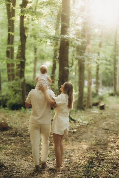 istock a young family on a walk in the woods 2184164395