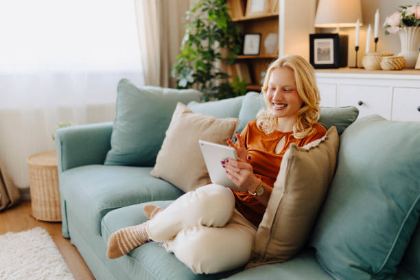 istock Albino woman using digital tablet at home 2184164524
