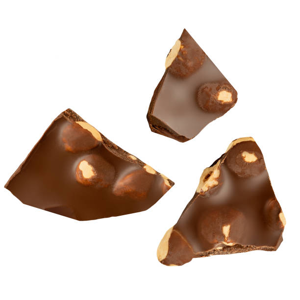 istock Chocolate with hazelnuts isolated on white. Broken chocolate bar pieces with hazel nuts. Creative layout.  Top view. Flat lay. 2184164702