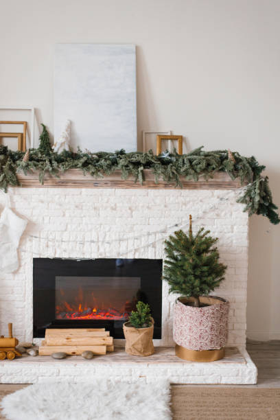 istock Fireplace with a Christmas tree in a pot at living room 2184166295