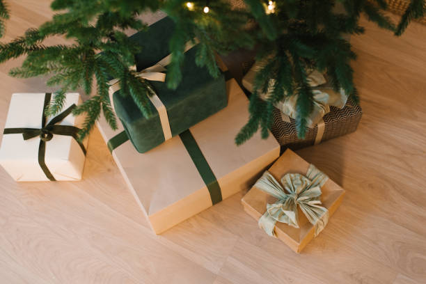 istock Stack of presents are on a wooden floor, with a green box in the middle 2184166301