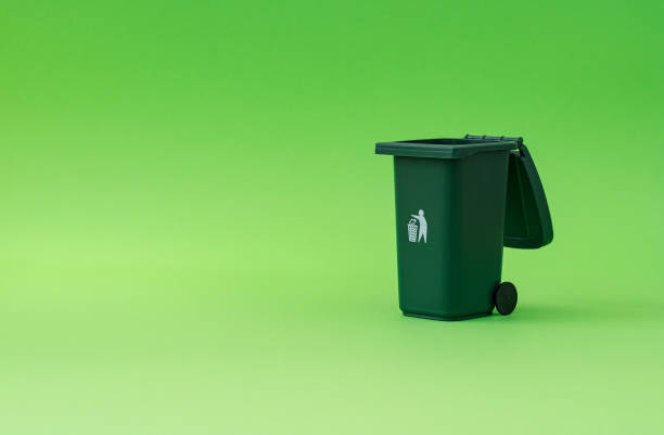istock Trash recycle bin against green background. Container for disposal garbage waste and save environment. Minimal earth day concept. Green eco idea. 2184166803