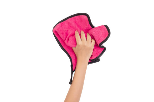 istock Human hand holding pink rag and wiping table or cleaning something isolated on white background with clipping path. 2184167354