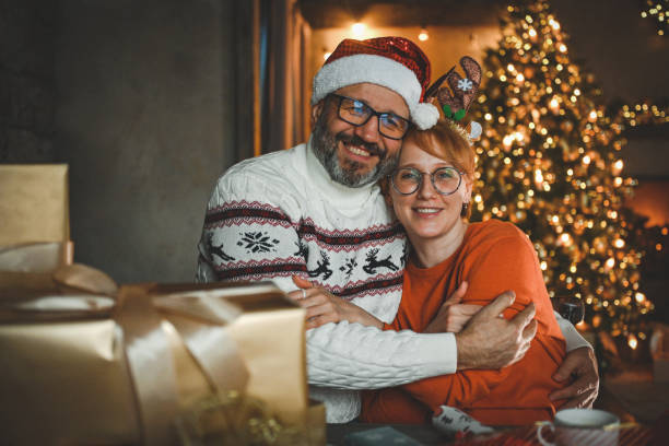 istock mature couple wrapping christmas presents 2184167438