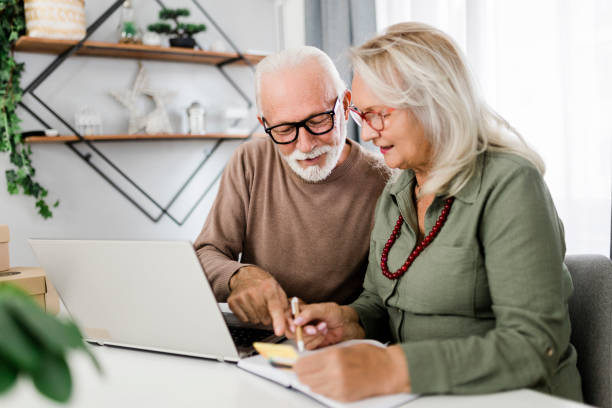 istock Senior couple shopping at home 2184167974