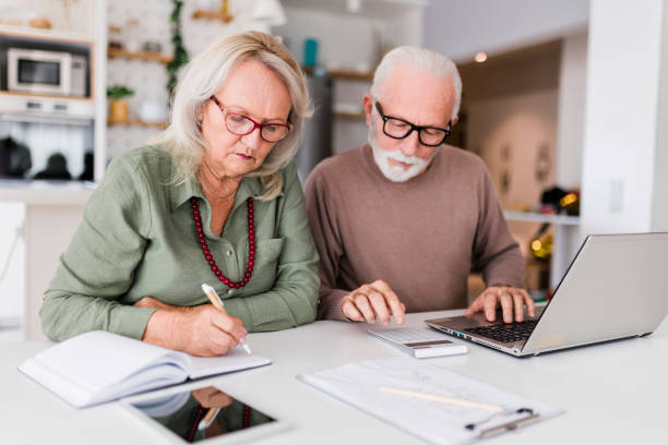istock Senior couple using laptop while planning their home budget, 2184168183