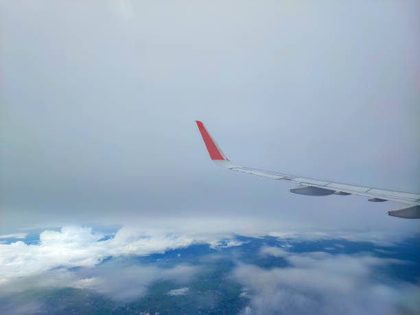 The airplane wing on the sky with white cloud.