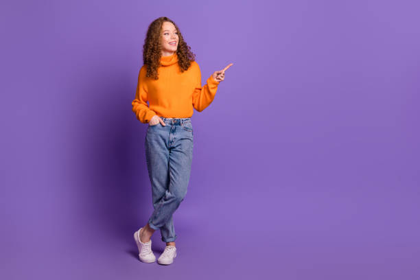 istock Full size photo of nice young girl point finger empty space wear pullover isolated on violet color background 2184168413