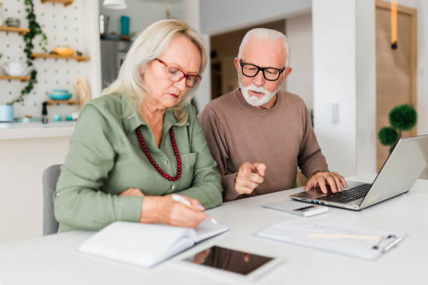 istock Senior couple using laptop while planning their home budget, 2184169222