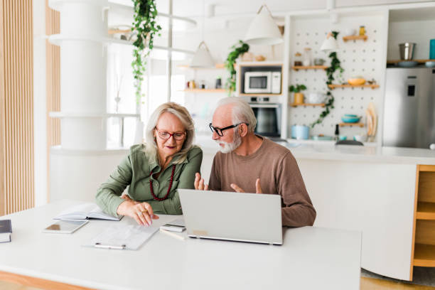 istock Senior couple using laptop while planning their home budget, 2184169554