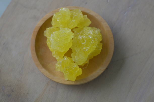 istock yellow rock sugar on a wooden plate 2184170208