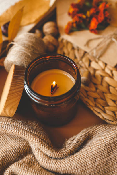istock Burning candle in a cozy warm homey autumn atmosphere 2184172848