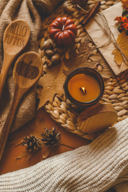 istock Burning candle in a cozy warm homey autumn atmosphere 2184172849