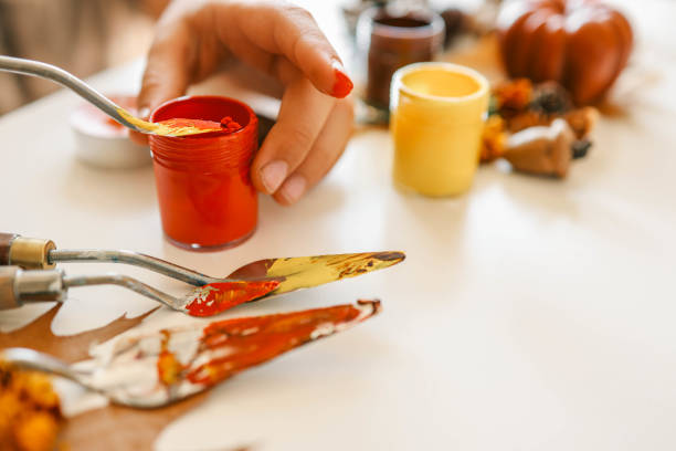 istock Creative autumn art activity with paint and natural materials like pine cones, acorns, and chestnuts, crafting seasonal decorations 2184173030
