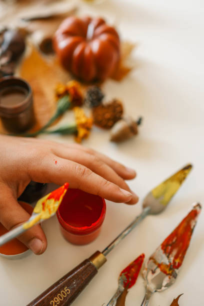 istock Creative autumn art activity with paint and natural materials like pine cones, acorns, and chestnuts, crafting seasonal decorations 2184173032