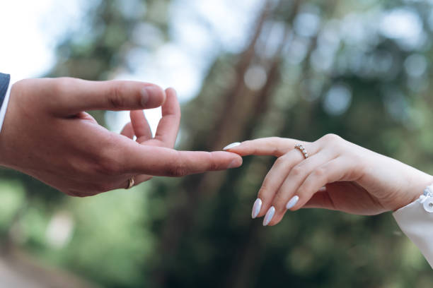 istock bride and groom touch each other with one finger 2184173574
