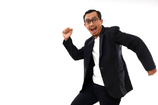 istock Happy Asian male office worker running jumping looking at the camera. Isolated on white 2184174209