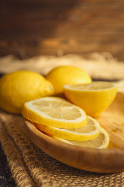 istock Fresh and juicy lemon on a dark rustic background 2184175040