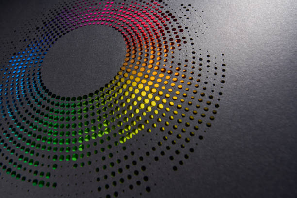 istock Perforated circular paper artwork with vibrant gradient of rainbow colors on dark background for modern decor 2184176162