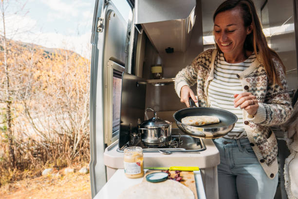 istock Woman Preparing a Wrap in Camper Van Kitchen 2184176194