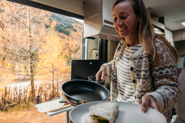 istock Woman Preparing Fresh Wraps in Camper Van 2184176246