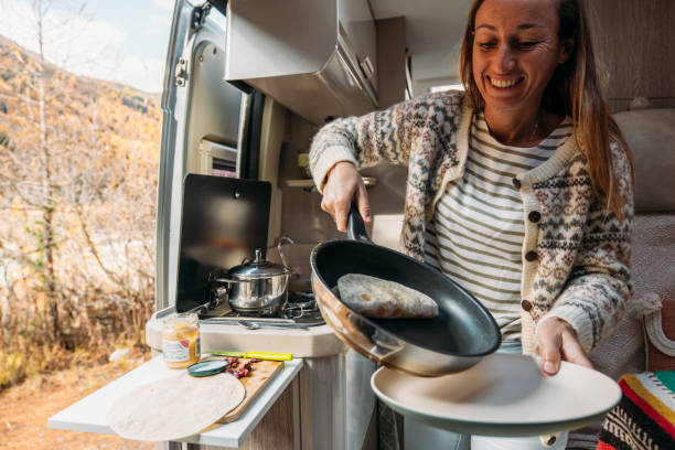 istock Woman Preparing a Wrap in Camper Van Kitchen 2184176506