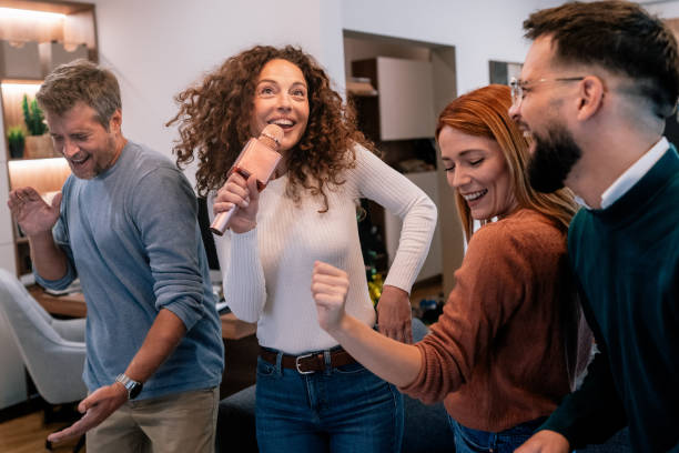 istock Friends playing karaoke at home 2184176559