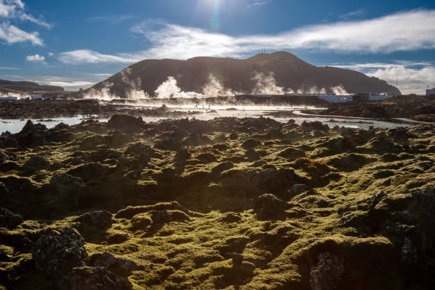 Woman in beauty face mud mask floating in the hot turquoise thermal pool in Iceland